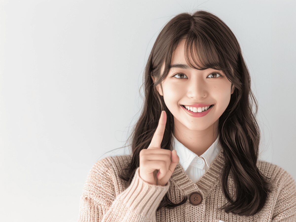 人差し指を立てる女子高生