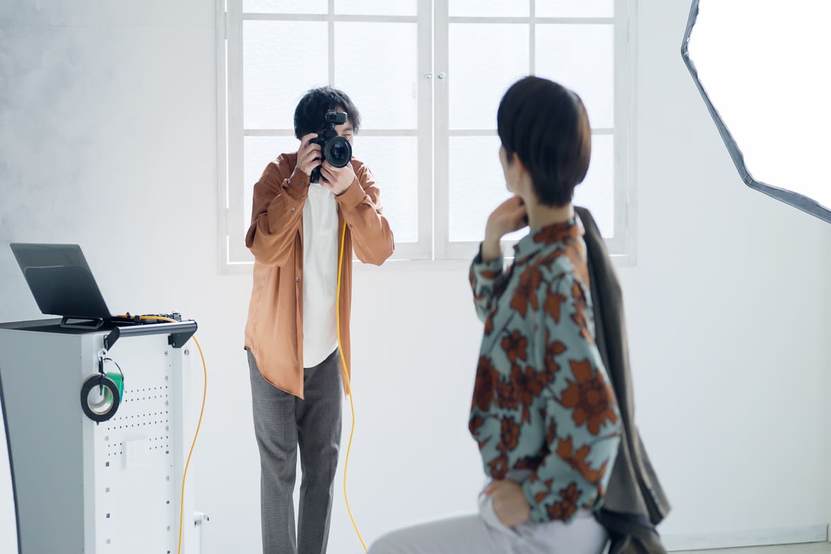 撮影する男性カメラマンと女性モデル