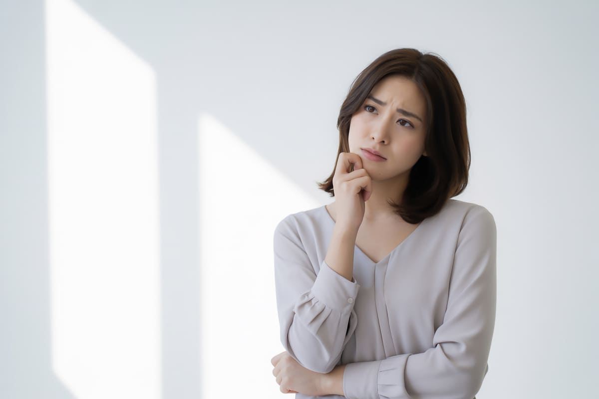 白背景と悩む女性